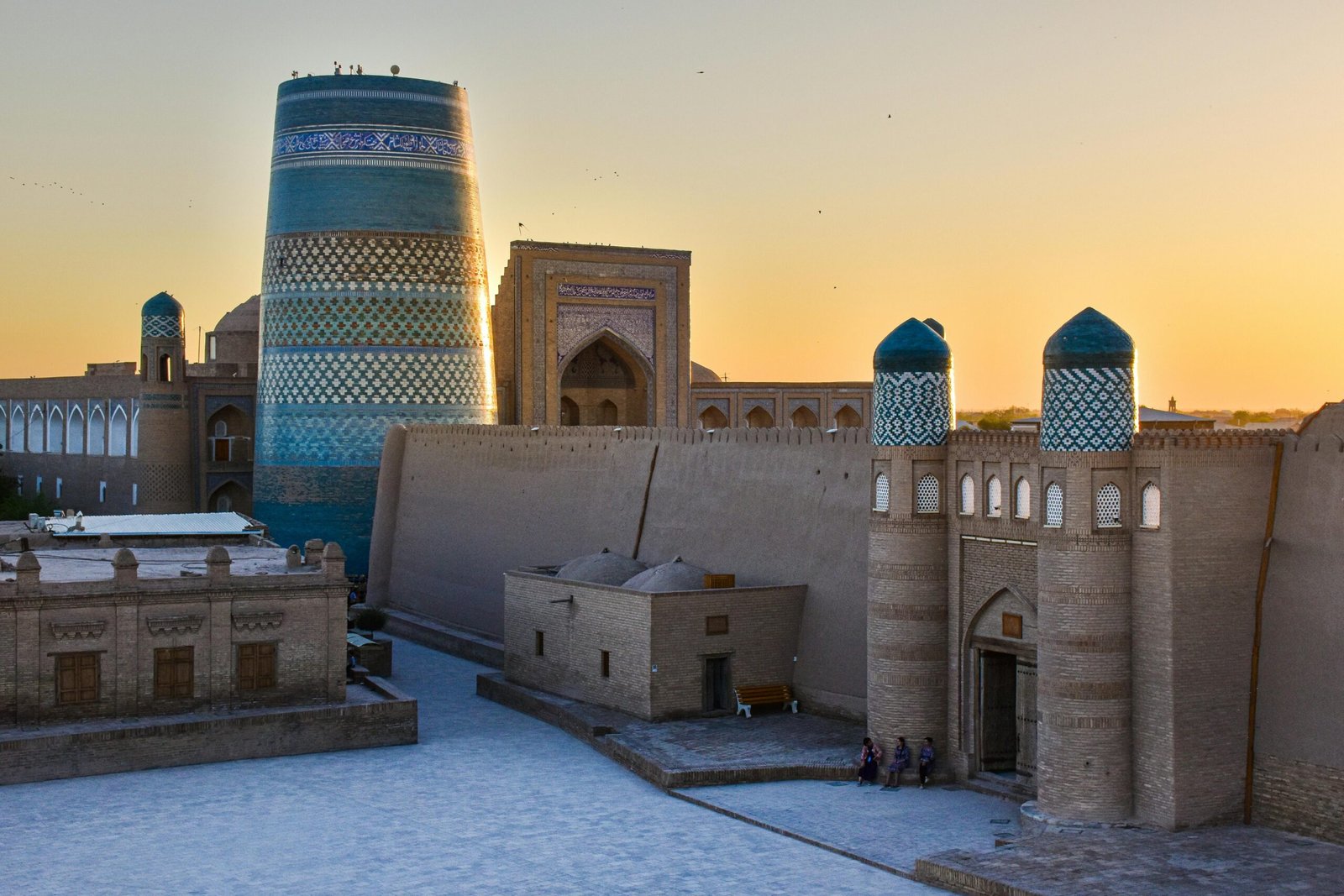 View of Kalta Minor Minaret in Khiva, Uzbekistan at sunset, highlighting its stunning architecture.