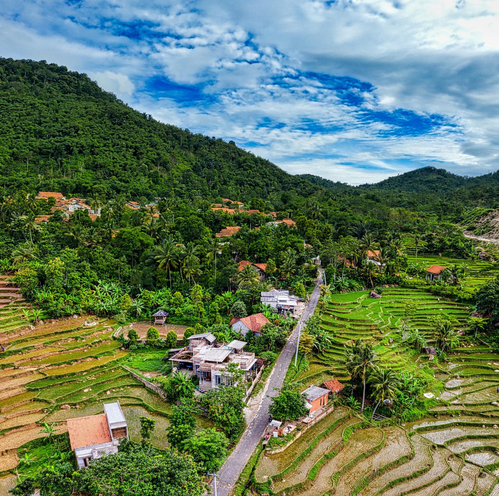Scenic aerial shot of rice terraces and village in Purwakarta, West Java.